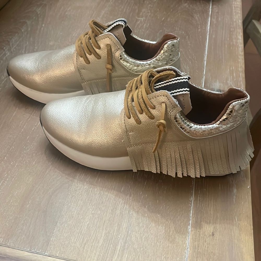 Shushop gold sneakers.